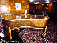 Piano to the right of the Front Desk