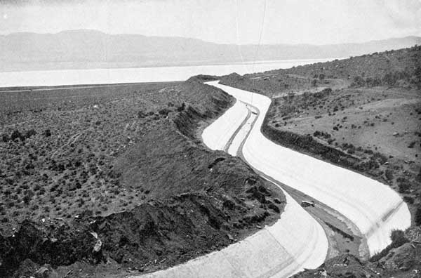 The Los Angeles Aqueduct next to a filled Owens Lake